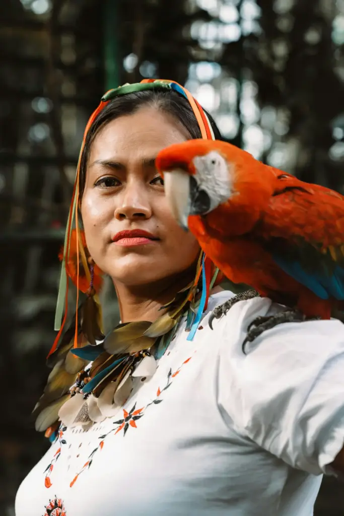 Lady with a scarlet macaw on shoulder Languages of the Peruvian Amazon